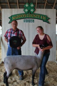 Loan Operations Specialist Cheyenne Morgan showing sheep at the Madison County Fair. Cheyenne is now the Sheep Barn Superintendent in Warren County.