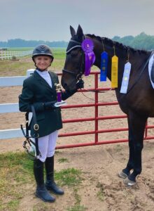 Haylee with her horse and ribbons