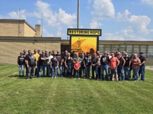 Participants of the Patriot Ride for Restoring Hope paused for a photo outside the new facility.